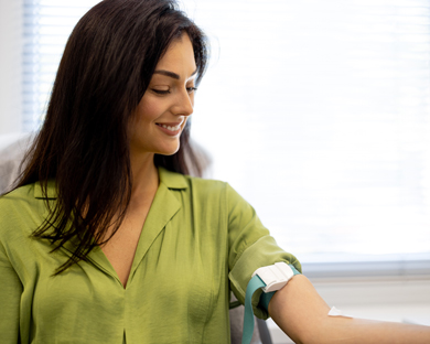 woman having arm cuffed for blood testing