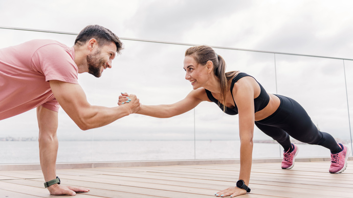 couple workout, push ups holding hands for balance